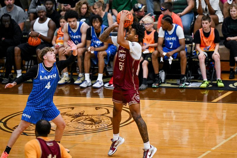 Team Faygo and Michigan State's Jasiah Jervis, right, shoots a 3-pointer during the Moneyball Pro-Am championship game on Thursday, July 30, 2026, at Holt High School.