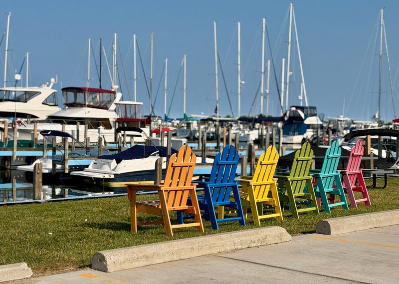 Colorful Adirondack chairs overlook the Port Sanilac Marina on July 30, 2026, in Port Sanilac.