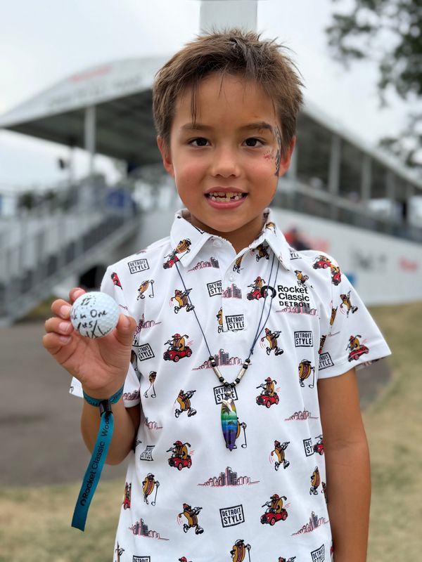 Casimer Daniewski, 7, of Detroit, shows off the hole-in-one ball given to him by Matt Kuchar during Friday's second round of the Rocket Classic at Detroit Golf Club on Friday, July 31, 2026.