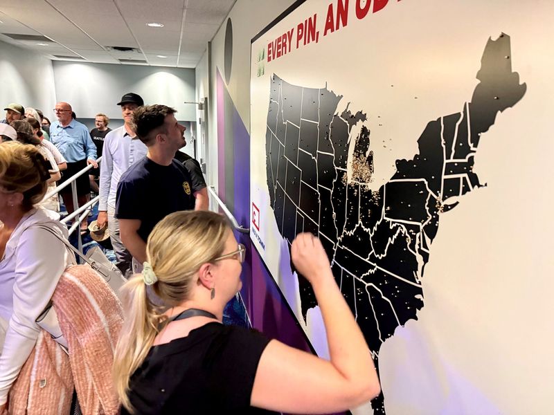 Filmgoers pin their hometowns on a map of the U.S. at Celebration! Cinemas North in Grand Rapids on Aug. 3, 2026.