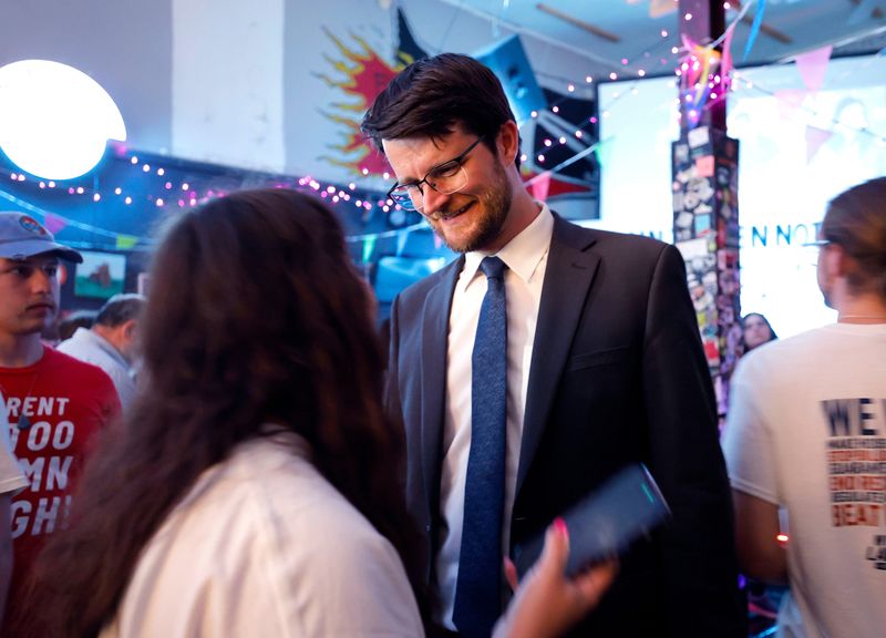 U.S. House 7th Congressional District Democratic candidate William Lawrence talks with supporters, Tuesday, Aug. 4, 2026, at The Avenue Cafe in Lansing on primary election night in Michigan.