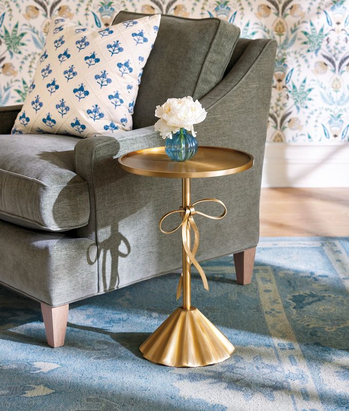 A side table with a sculpted bow strikes a celebratory tone in the home. (Ballard Designs)