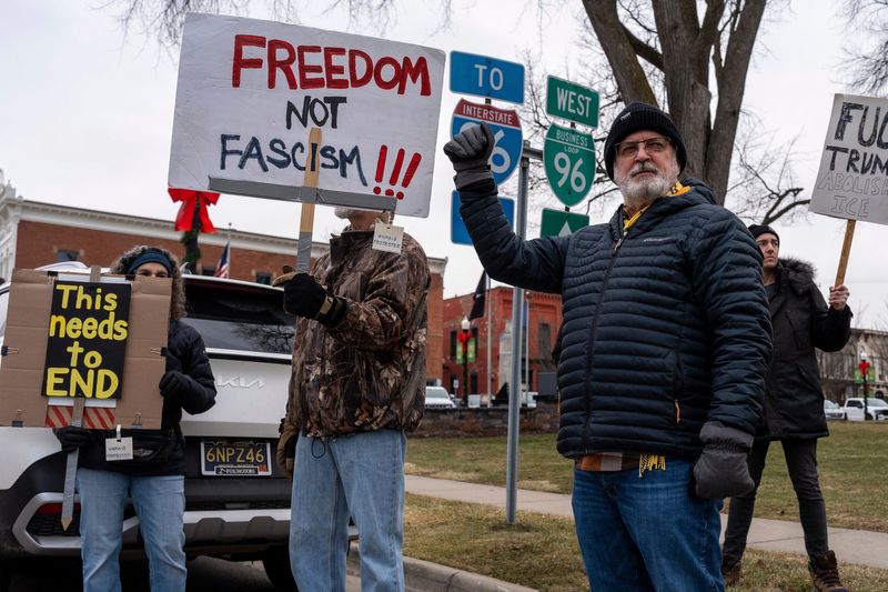Curtis Hamilton, a Howell resident, holds his fist in the air during a “We Are All Renee Good” anti-ICE rally in Howell on Saturday, Jan. 10, 2026.