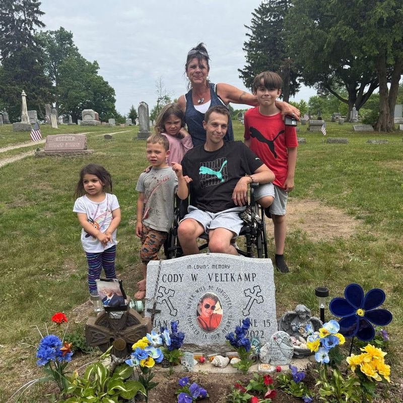 Shane Veltkamp, center, at his brother's grave site after he spent time in jail and prison and become disabled from multiple sclerosis. Veltkamp's brothers death led to drug use which ultimately landed him in prison.