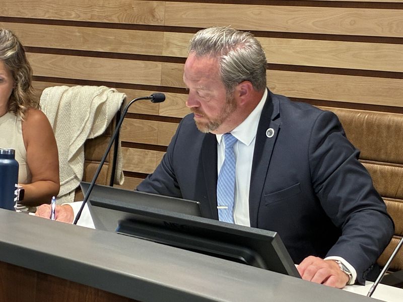 Orion Township Supervisor Chris Barnett takes notes following a vote on Friday, Aug. 7, 2026, at the township's municipal offices.