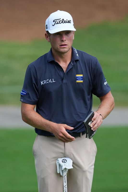 Michael Brennan pulls out his scorecard on the 17th green during the third round of the Wyndham Championship.