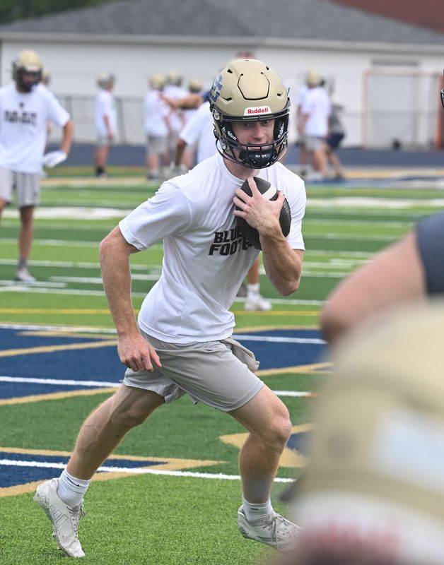 Quarterback Sam Rouleau, a CMU commit, goes through drills during Grosse Pointe South football's first official practice on Monday.