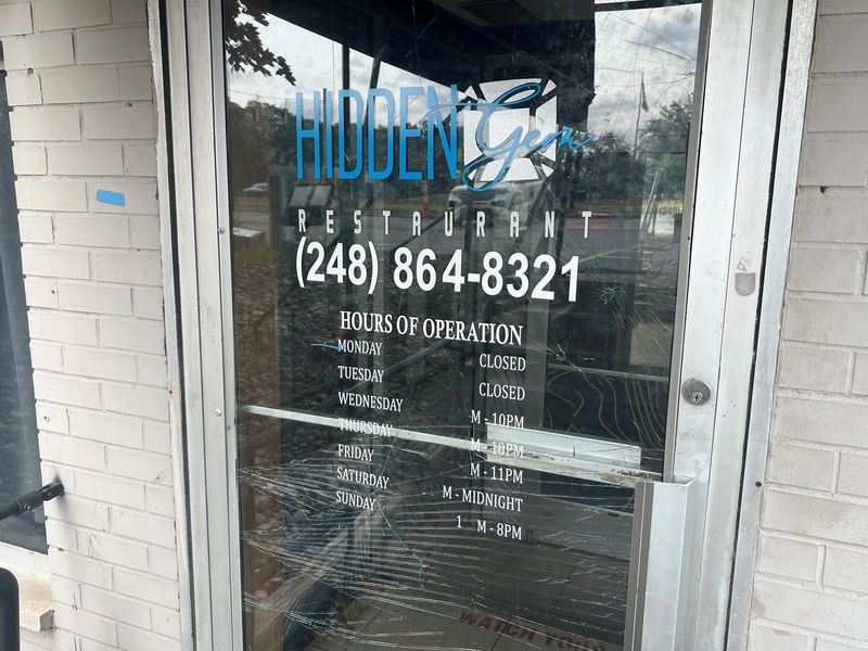 The shattered front door of Hidden Gem Restaurant, 16000 W. Nine Mile Road, as shown on Aug. 10, 2026. The day before, at about 3:30 a.m., the restaurant was the site of two fatal shootings.