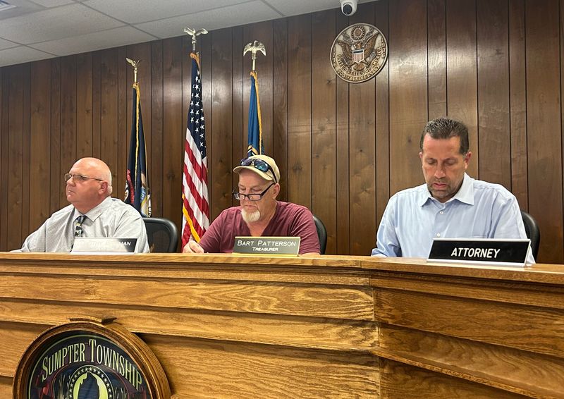 Sumpter Township Clerk Don LaPorte, Supervisor Timothy Bowman and Treasurer Bart Patterson work during a township trustee meeting, Monday, Aug. 10, 2026, at the township administration building.