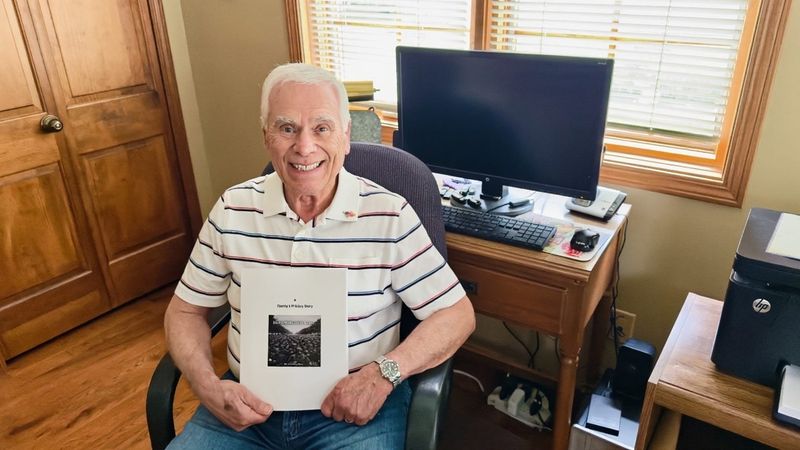 Retired Monroe High School educator and coach Vincent Rossi holds his new book, “Honoring The Call: A Family's Military Story."