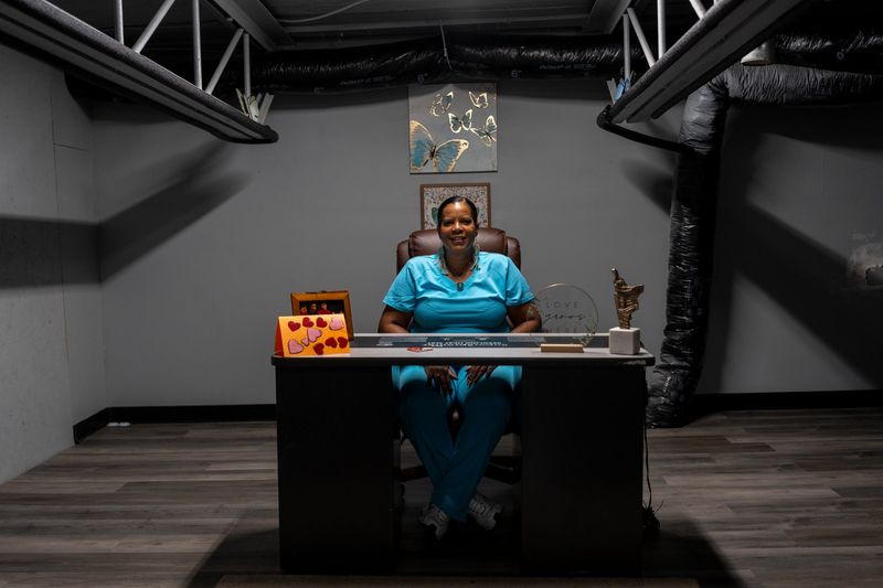 Felicia Legardy, 60, owner of Crystal Swann Child Care and founder of Crystal Health & Herbs, sits behind a desk inside the future home of Crystal Health & Herbs in Detroit on Wednesday, Aug. 12, 2026. Legardy is closing her childcare business after 30 years and hopes her new cannabis venture will help provide financial security for herself and her family.