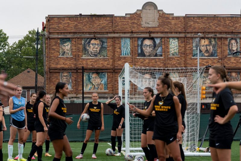 Wayne State women’s soccer players gather near a goal during a morning practice at the Wayne State Soccer Complex in Detroit on Thursday, Aug. 13, 2026.