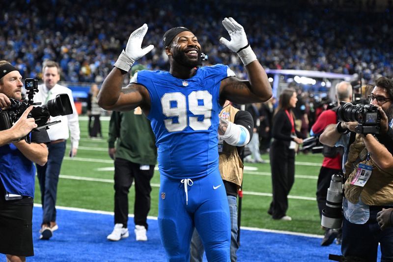 Dec 5, 2024; Detroit, Michigan, USA;  Detroit Lions defensive end Za'Darius Smith (99) celebrates with the fans as he walks off the field following the Lions win over the Green Bay Packers at Ford Field. Mandatory Credit: Lon Horwedel-Imagn Images