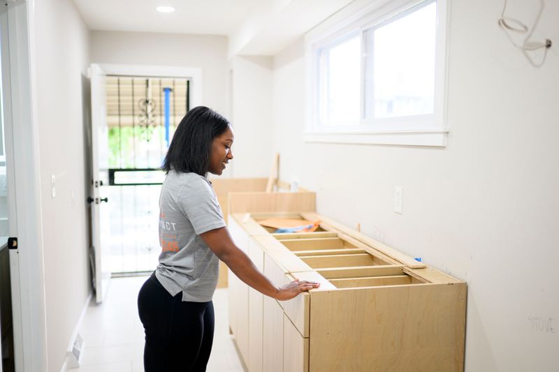 Chauny Barnes-Sailor, CEO of Always IMPACT, checks out newly installed cabinets in the kitchen of a home on Clairmount Street in Detroit on Aug. 17, 2026. Barnes-Sailor is a recent graduate of the inaugural class of the Ignite Detroit Contractors Program, a free program funded by the Gilbert Family Foundation that's designed to help early-stage construction contractors in Detroit develop the skills needed to grow their businesses.