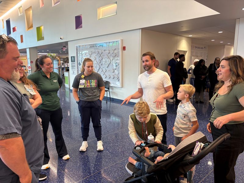 The Waatti family of Rochester Hills, including Edison Waatti, pictured in a stroller, talks with nurses at Children's Hospital of Michigan who cared for Edison earlier this year during a visit to the hospital on Monday, Aug. 17, 2026.