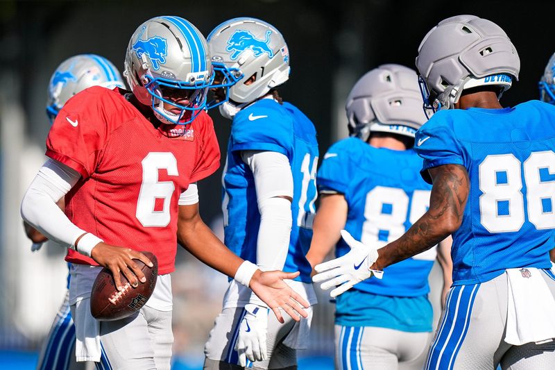 Detroit Lions quarterback Josh Dobbs (6) shakes hands with wide receiver Cedrick Wilson Jr. (86) during training camp at Meijer Performance Center in Allen Park on Monday August 17, 2026.
