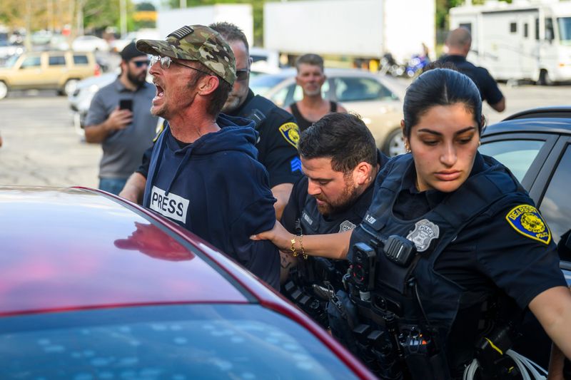 Dearborn Police arrest a protester as groups clash before anti-Muslim activist Jake Lang attends a Dearborn City Council meeting on Tuesday, Aug. 18, 2026 in Dearborn, Mich.