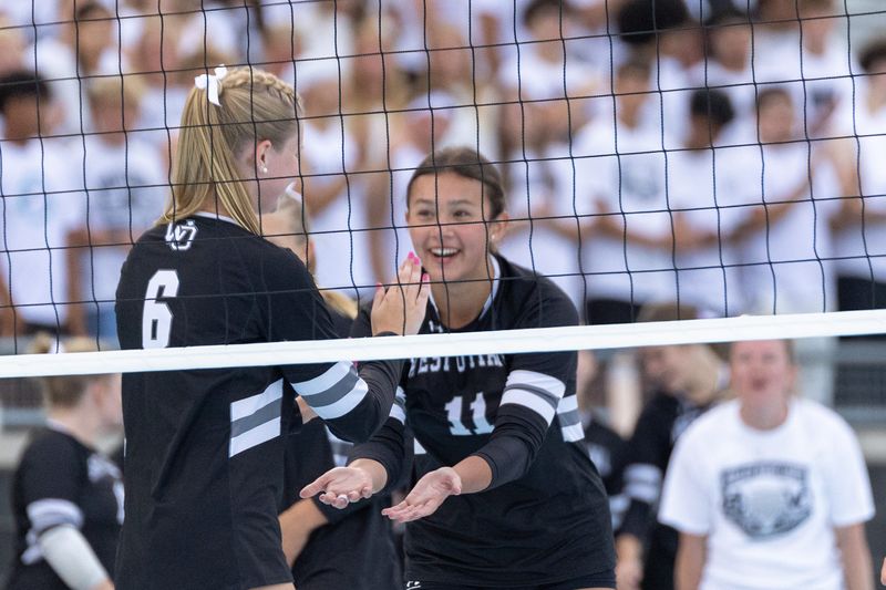 West Ottawa's Kinley Mares high fives Madi Hanko on Friday, Aug. 21.