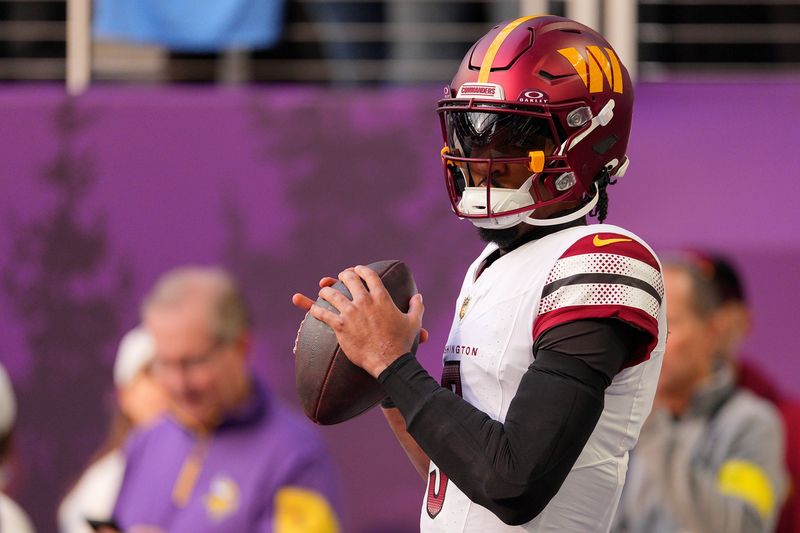 Dec 7, 2025; Minneapolis, Minnesota, USA; Washington Commanders quarterback Jayden Daniels (5) practices before the game at U.S. Bank Stadium. Mandatory Credit: Brad Rempel-Imagn Images
