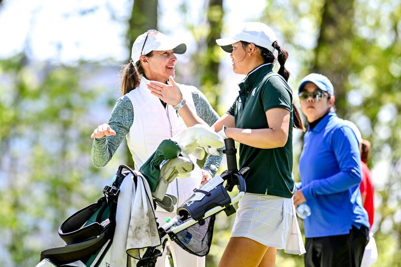 Michigan State women's golf coach Stacy Slobodnik-Stoll, left, talks with Michigan State's Katie Lu during the final round of the NCAA women's golf regional on Wednesday, May 8, 2024, at Forest Akers West Golf Course in East Lansing.