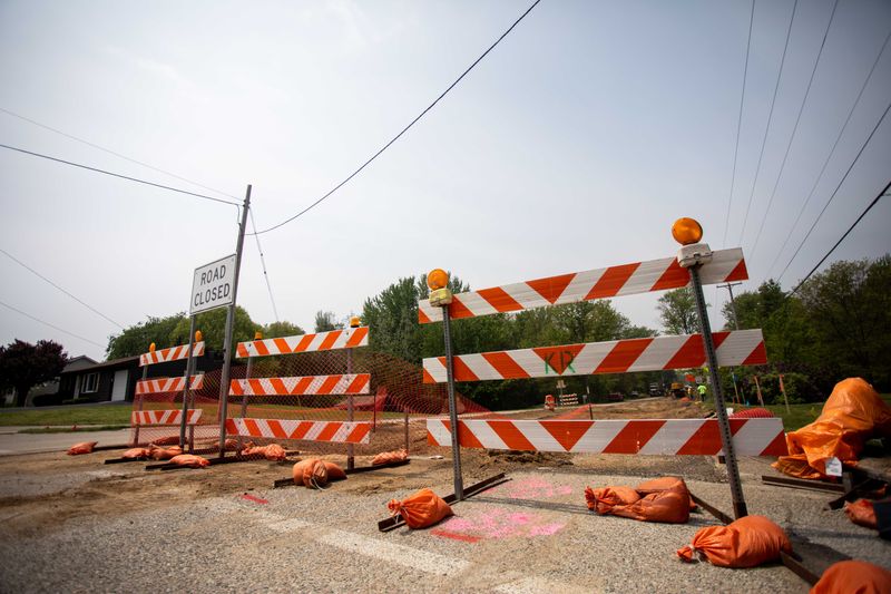 Crews work to replace pavement Thursday, May 19, 2022, on Lakewood Blvd in Holland Township. Road construction is taking place throughout the greater Holland area.