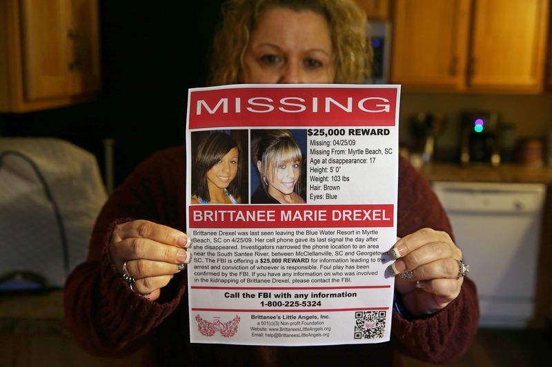 Dawn Pleckan, the mother of Brittanee Drexel, holds a pamphlet for a foundation she created to help families going through a missing person case.