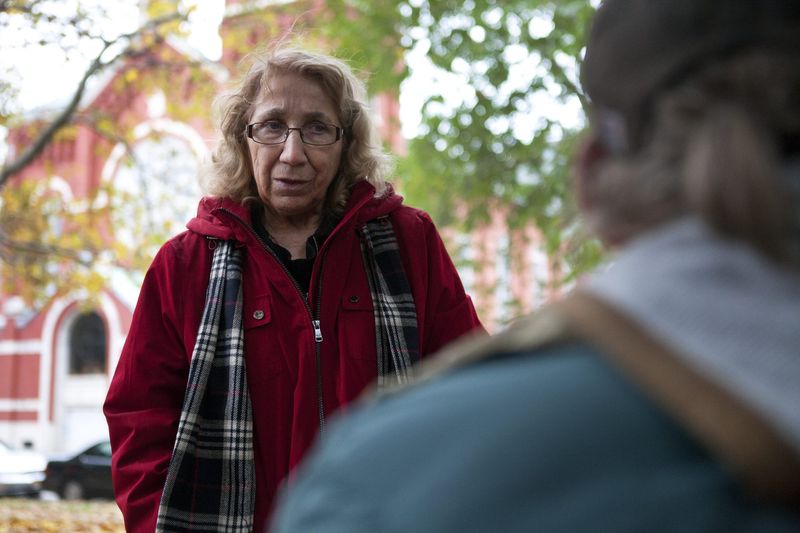 Sister Grace Miller with the House of Mercy speaks with a homeless man about whether or not he wants to stay another night in Washington Square Park on Oct. 22, 2014. Tents were put up in the park by advocates headed by Miller in an effort to fight for more housing.