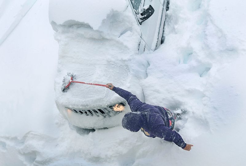 THE PHOTO: Eastbrooke Community resident in Brighton, Jazzlin Allen clears the snow of her car which she left in the driveway overnight, in order to go pick up a pizza during Winter Storm Stella. Pizza delivery was up to at least a two hour wait. FROM CARLOS: I found it funny that though dealing with such weather crisis in this image, it's pizza that gets the attention. And hey, on a day like that were pretty lucky to have ovens fired up to feed us!