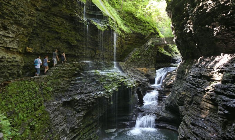 Visitors walk along the Gorge Trail and pass underneath the iconic Rainbow Falls at Watkins Glen State Park. The park had over 1.2 million visitors in 2024.