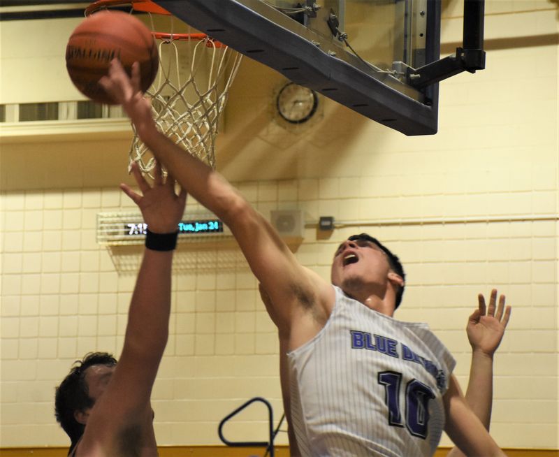 Dolgeville senior Kamryn Comstock (10) joined the Blue Devils' 1,000-point club when he put back an offensive rebound in the first quarter of a Tuesday, Jan. 24, 2023, game against Canastota in Dolgeville, New York. **(not this shot)**