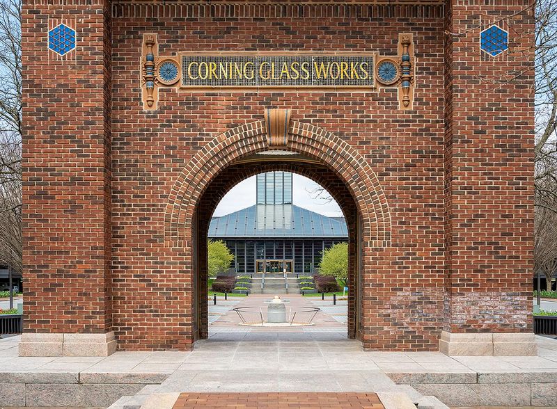 The entrance to Corning Inc. Global Headquarters in Corning is seen through the historic arch that bears the company's former name.