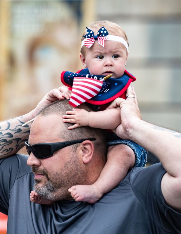 Makenna Riecke, 8 months, takes in the Peekskill 2023 Independence Day Parade from the shoulders of her grandfather Mike of Buchanan July 4, 2023. Hundreds lined the streets of downtown as numerous fire departments, bands, elected officials and other organizations marched. Following the parade, there was live music at Riverfront Green.