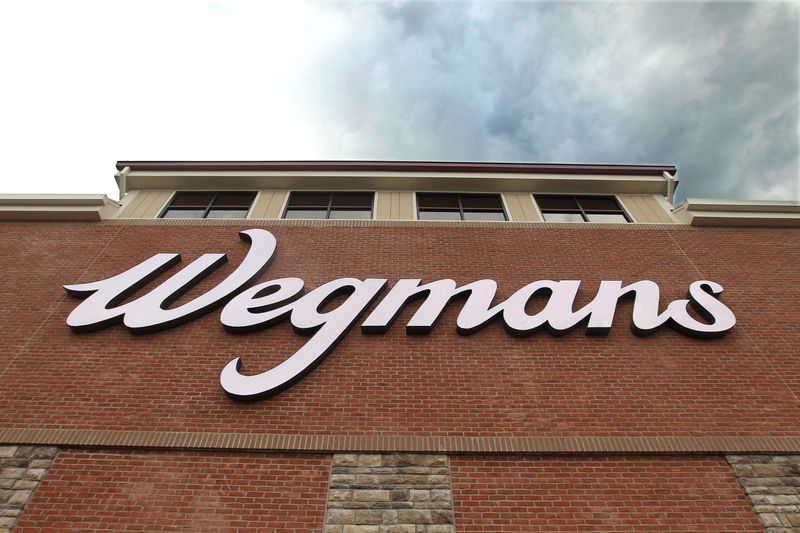 Wegmans sign looms over the entrance of the new East Ave store.