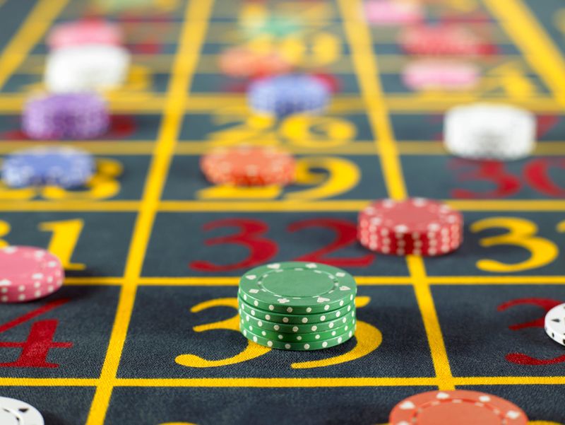 Gambling chips on roulette table.