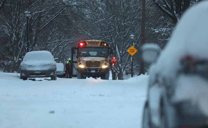 A school bus stops on a snow covered road in Rochester to pick up a student. “A school bus is the safest form of travel. They’re built like tanks for obvious reasons." said Renee Reagan of the Webster School District.