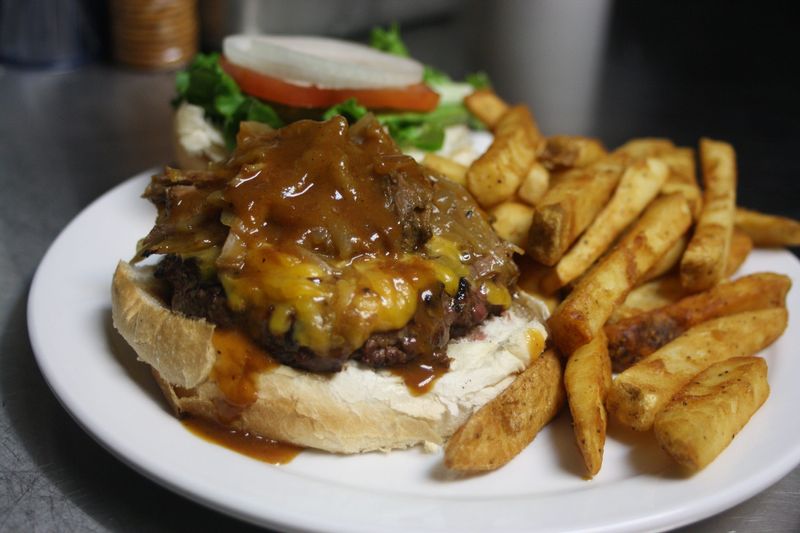 The Smokehouse Burger is a permanent menu item at The Pour House Pub and Grill in Johnson City. The burger is topped with pulled pork, Carolina barbecue, cheddar cheese and beer-braised onions.