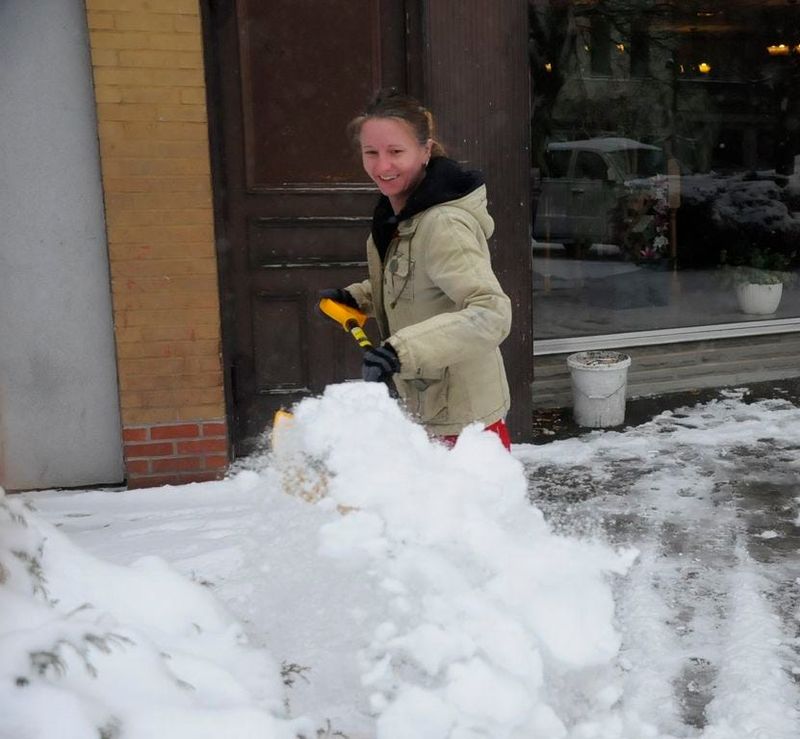 A shoveler clears snow from in front of the Texas restaurant in Hornell in this file photo.