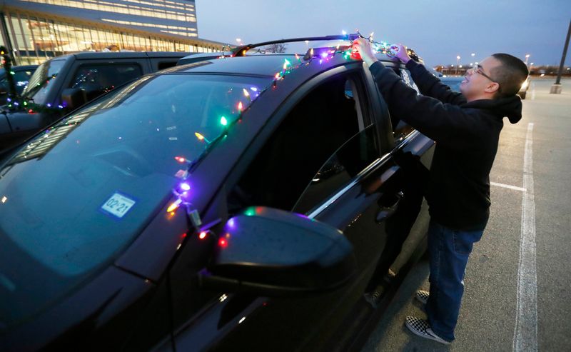 Sebastian Contreraz decorates his car with Lights. The Lubbock Chamber of Commerce and the City of Lubbock held a “Drive of Good Cheer” Christmas Car Parade Friday, Dec. 18. Participants decorated their cars in an effort to celebrate Christmas throughout the city. The car parade started at the Lubbock Memorial Civic Center and drove by both UMC and Covenant hospitals to thank all the health care workers for what the do.
