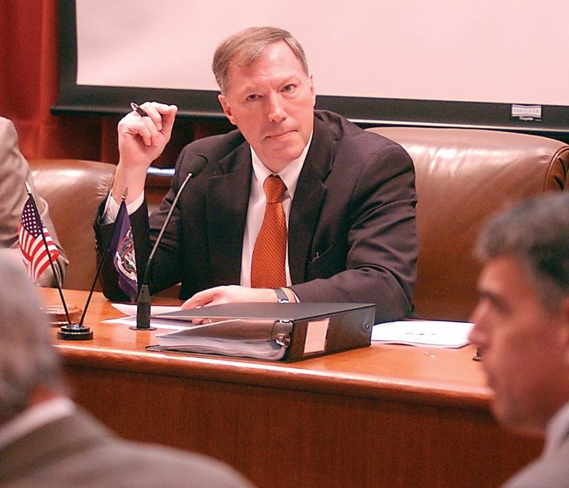 Philip Roche, Steuben County Chairman, listens to a legislator during a meeting.