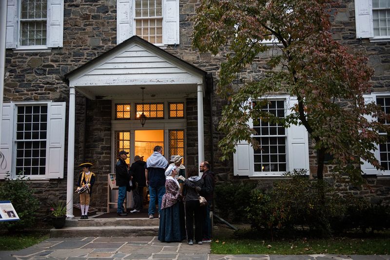Colonial reenactors and history revelers wait outside the Senate House as colonialist reenactor Hank Yost leads a presentation on the Burning of Kingston in the City of Kingston, NY on Friday, October 13, 2017.