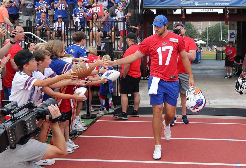 Bills quarterback Josh Allen is greeted by fans as he trots onto the field at the start of training camp in 2023.