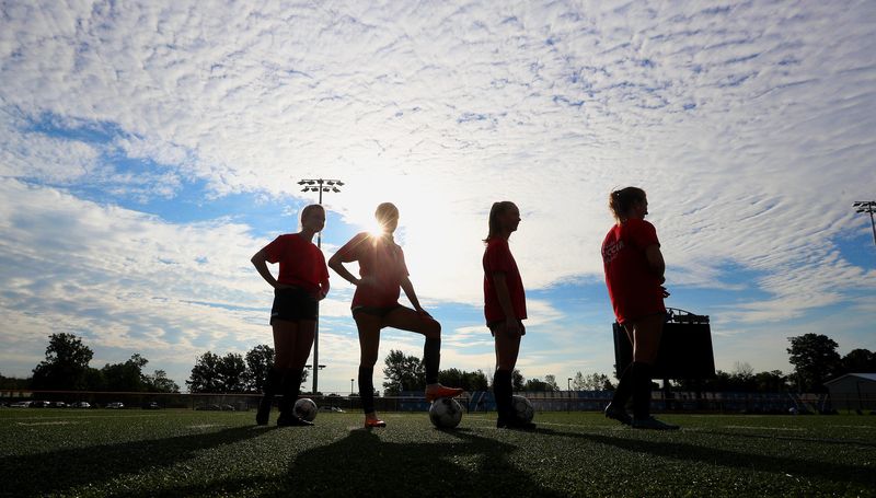 Webster Schroeder girls’s soccer players wait their turn during a shooting drill at an early morning practice.