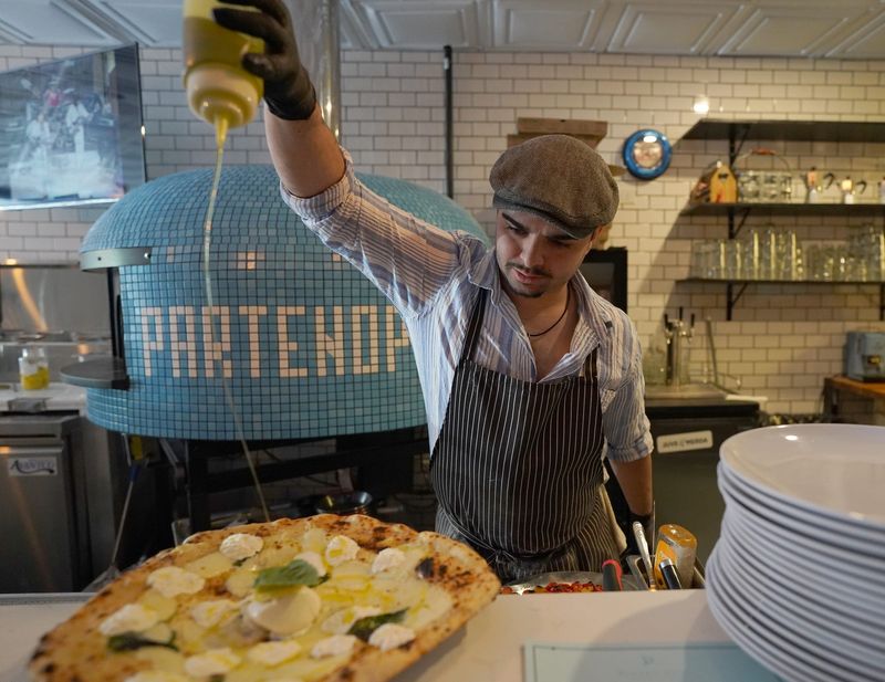 Chef Daniel Nizzardini of Pizzetiello in Pearl River adds olive oil to a DAM (Diego Armando Maradona) pizza. Tuesday, August 29, 2023.