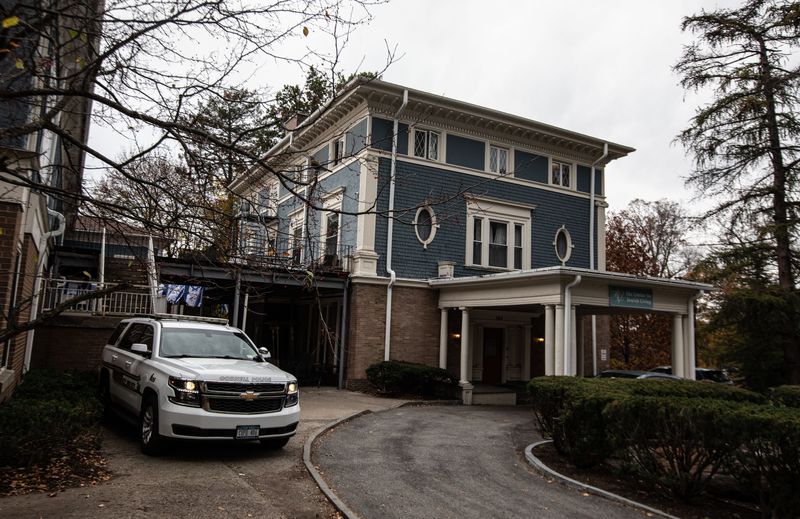 A Cornell University police officer sits in a car outside the Cornell Center for Jewish Living Nov. 6, 2023. The university provided security for the center after a student posted threats against Jewish students following Israel's response to the Oct. 7 attacks by Hamas.
