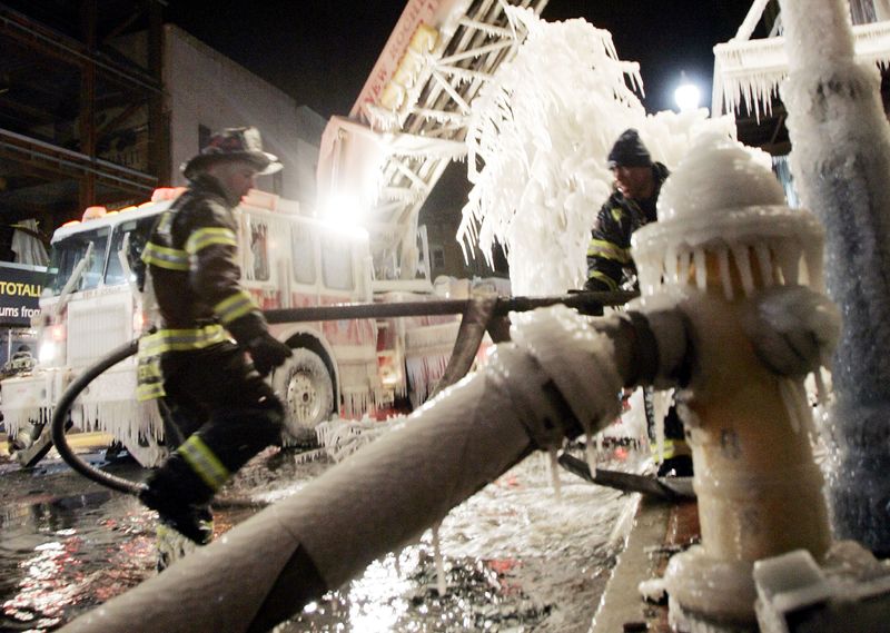 New Rochelle firefighters work at the scene of an early morning fire that destroyed several businesses along Main Street in downtown New Rochelle March 9, 2005. Firefighters had to battle the blaze, high winds and frigid temperatures. Water used to fight the fire was freezing on contact.