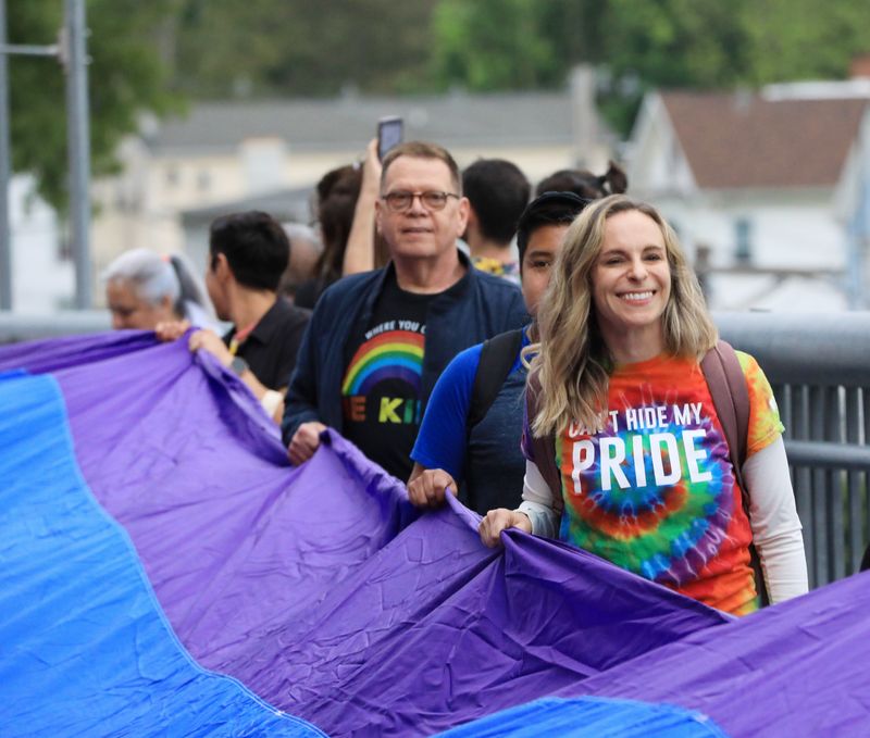 Participants carry a giant pride flag during the Pride in the Sky event at the Walkway Over the Hudson State Historic Park in Poughkeepsie on May 17, 2024.
