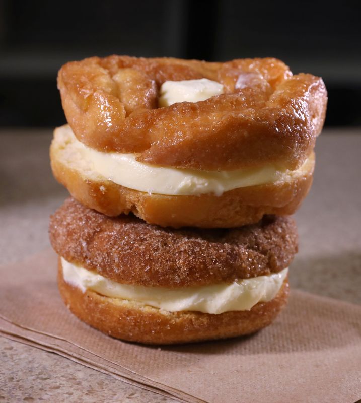 The popular fried cake ice cream sandwiches, featuring both cinnamon sugar (bottom) and glazed fried cakes, at Schutt's Apple Mill in Penfield Thursday, May 30, 2024.