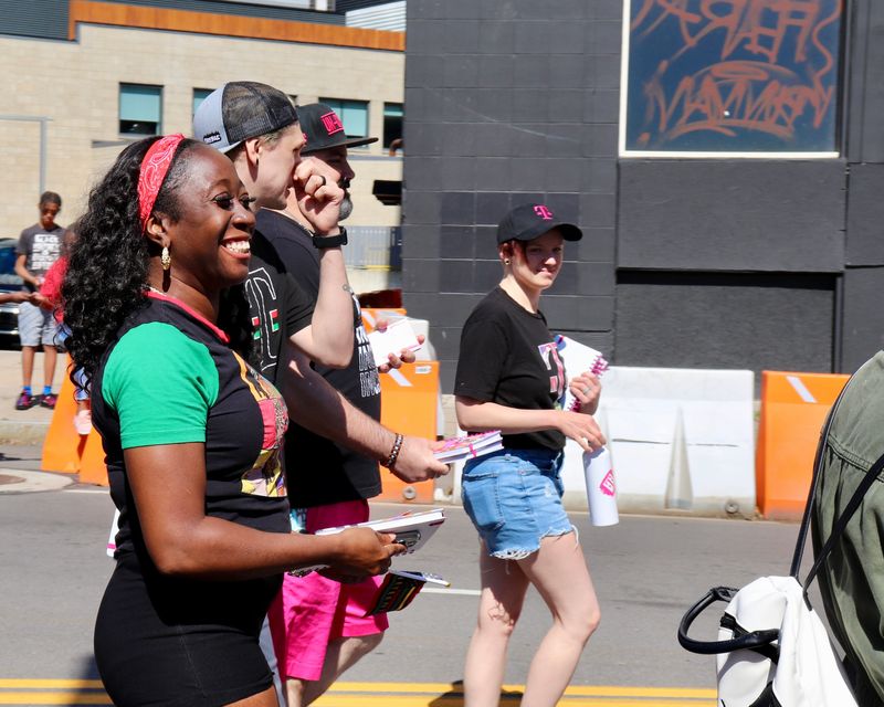 Smiling paraders talk and laugh while walking in the procession, which started at Martin Luther King Jr. Memorial Park and took a route around central Rochester.