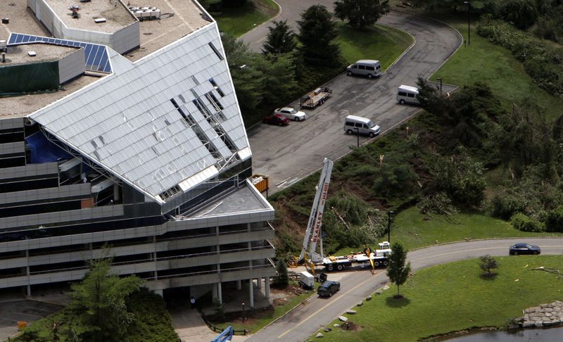 Workers replace windows caused by tornado damage at the Summit office park in Hawthorne July 12, 2006. The EF2 tornado hit parts of Mt. Pleasant, North Castle and Sleepy Hollow before crossing the Hudson and heading into Rockland.
