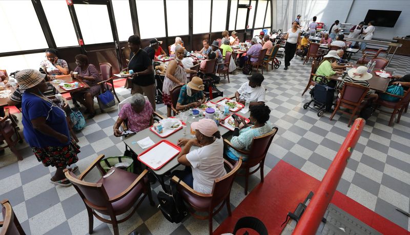 Senior citizens enjoy their lunch in the cool air of the Doles Center in Mount Vernon, during a heatwave July 16, 2024.